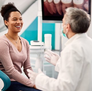 Woman smiling at dentist during appointment