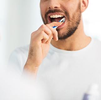 Closeup of patient brushing their teeth
