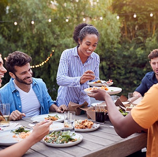 Group of friends enjoying meal together outside