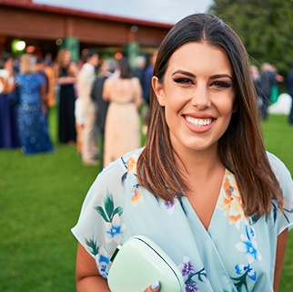 Wedding guest smiling while standing outside