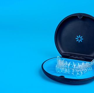 Invisalign trays in carrier case with blue background